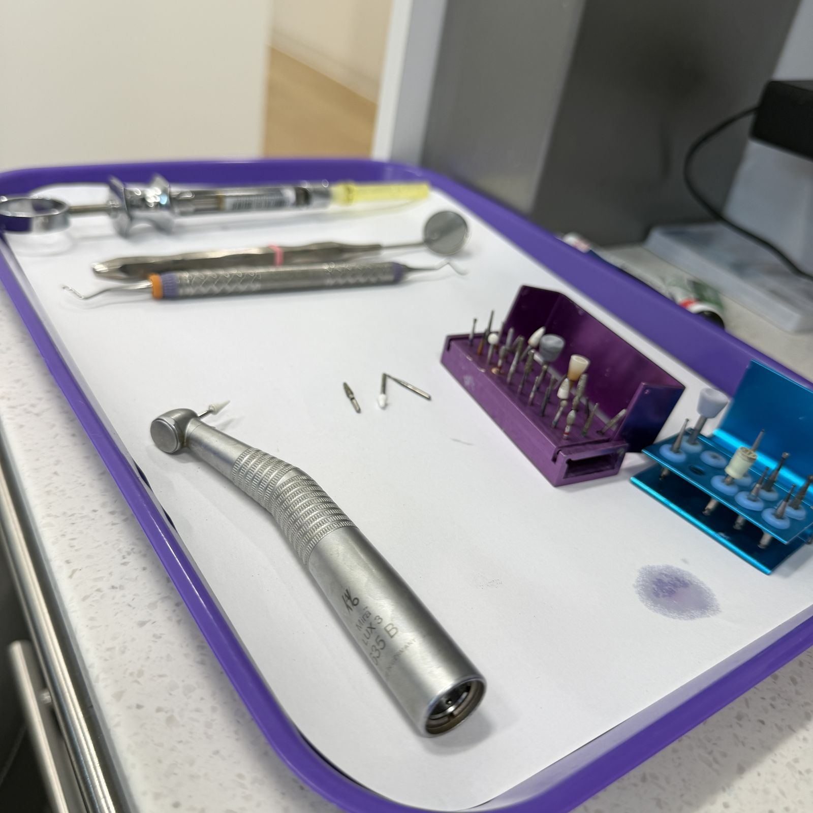 Dental handpieces laid out on a clean tray