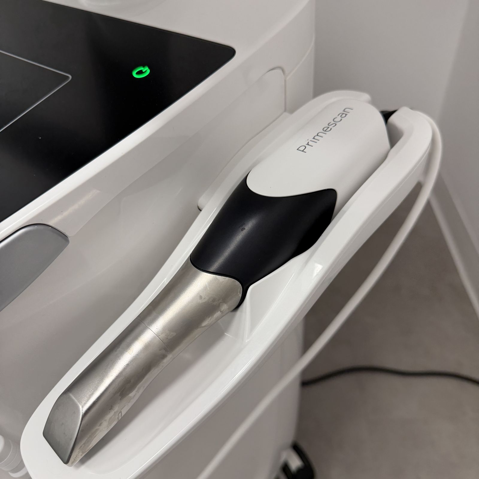 Primescan intraoral scanner wand in its cradle