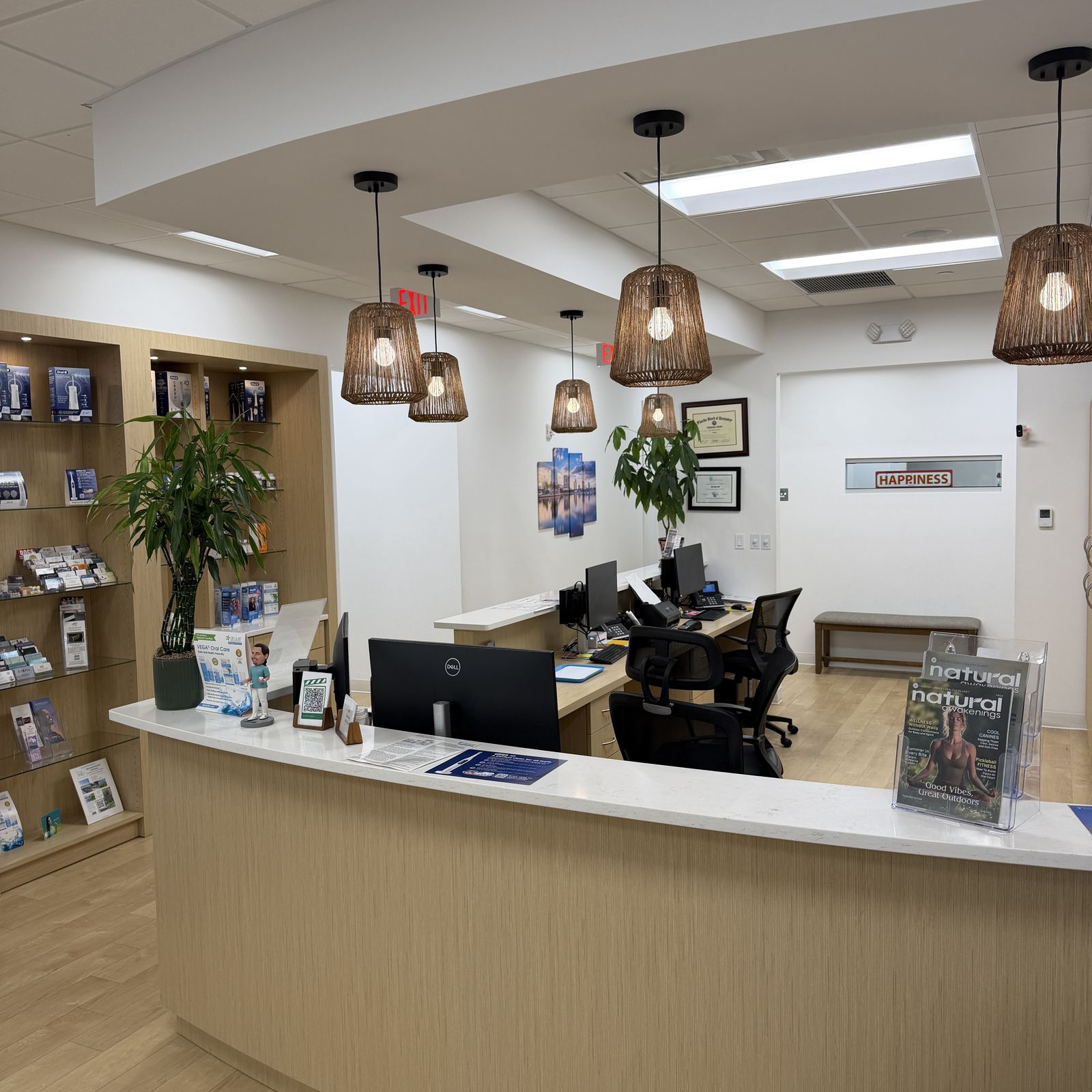 Natural Smiles reception desk with pendant lights and plants