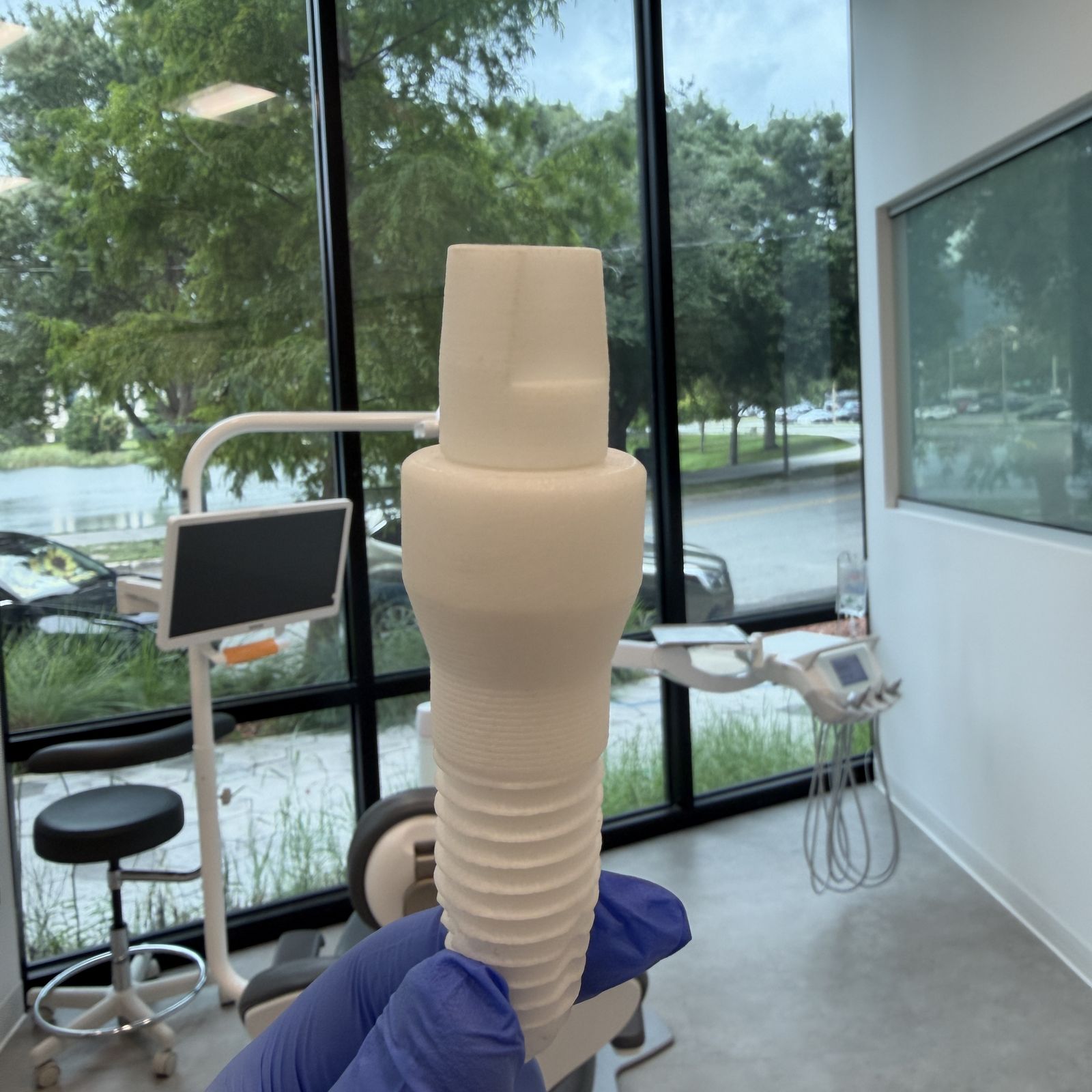 Zirconia ceramic implant held up in the Natural Smiles office